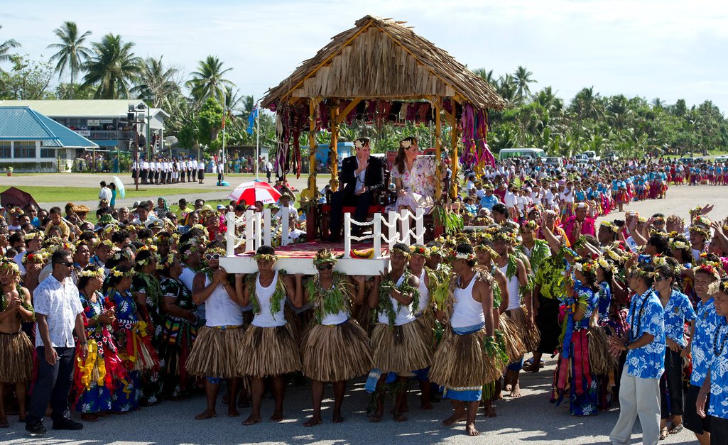 Prince William, Duke of Cambridge, and Catherine, Duchess of Cambridge, aka Kate Middleton, being carried on thrones on Tuvalu, on a tour of the Far East and Pacific as part of the Queen's Diamond Jubilee. 19 September 2012