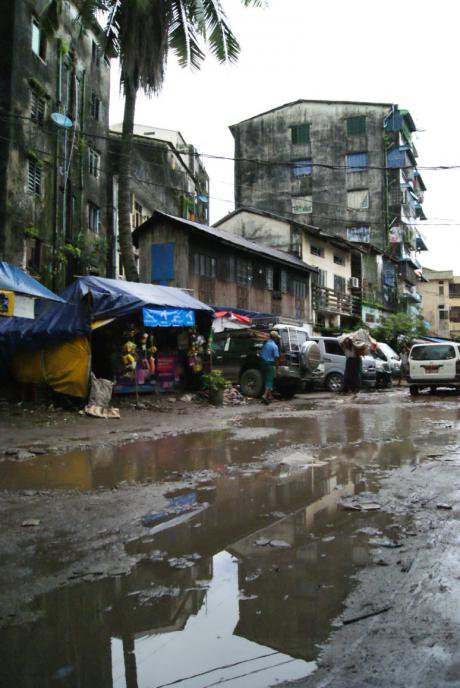 Muddy streets and worn infrastructure in Yangon. (Image by author)