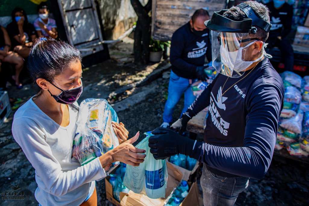 CUFA volunteers distribute food parcels to favela residents in Brazil