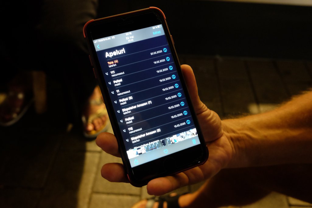 A hand holds up a phone, showing a screenshot of a user's call record