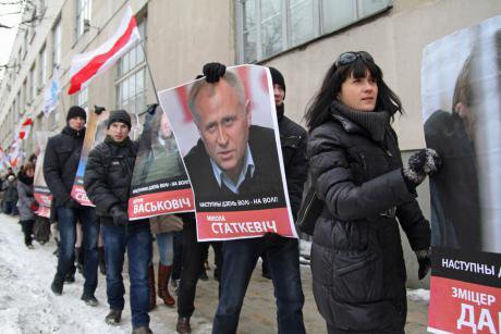 Protesters hold pictures of dead or imprisoned opposition activists as they walk through the streets of Minsk, March 2013