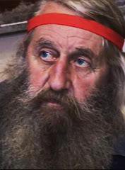Dobroslav, Slavic spirituality guru wearing a red headband and sporting a huge beard