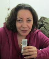 Woman with dictaphone smiles at camera 