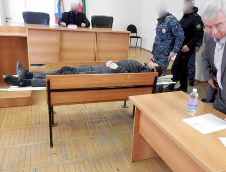 Edigov lying on a stretcher in court following his hunger strike. 