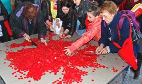People working with piles of red coins