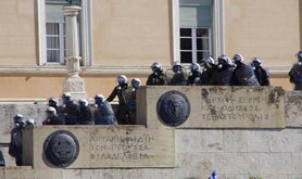 Greek riot police cascading down steps of a state building