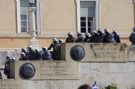 Greek riot police cascading down steps of a state building