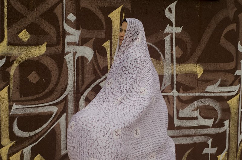 Figure 3 The Algerian artist Souad Douibi wearing a veil with an Arabic transcription of Freedom.jpg