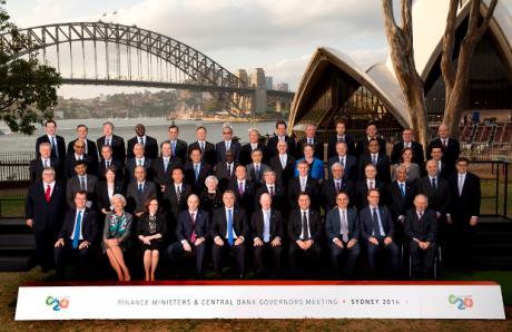 Be-suited officials in front of Sydney Harbour
