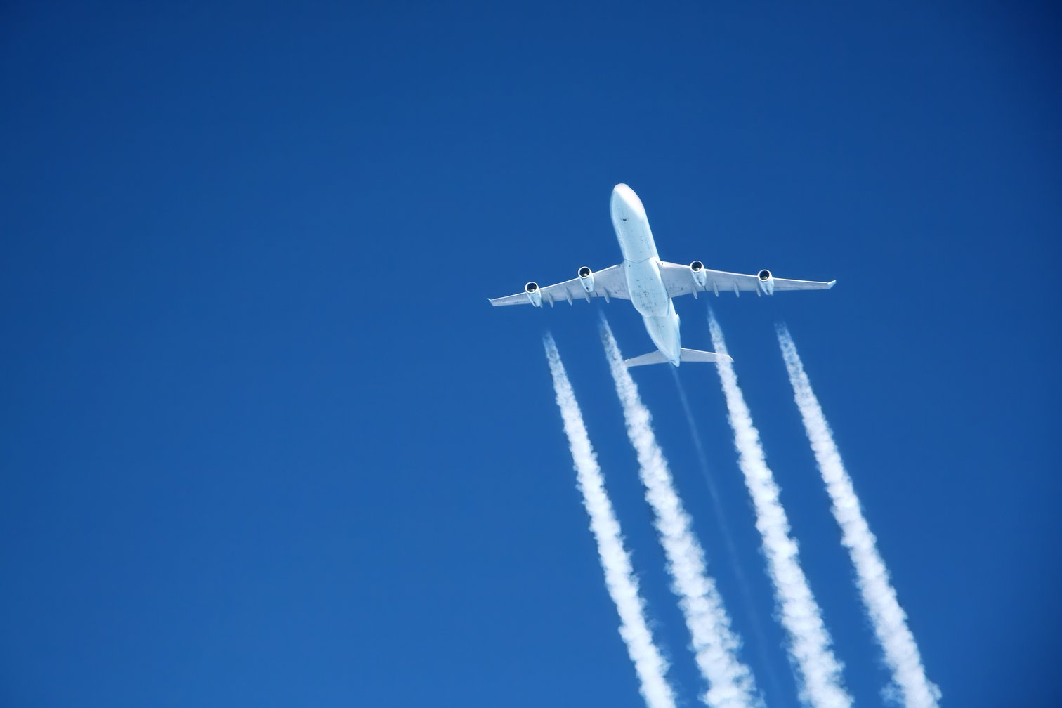 A jet flies in a blue sky | Getty