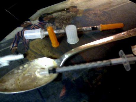 Heroin &#39;works&#39;, a syringe, a spoon and a needle. 