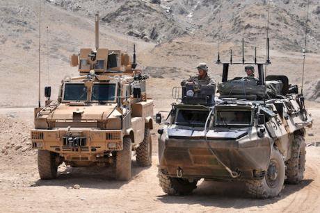 Two ISAF troop carriers in Afghanistan.