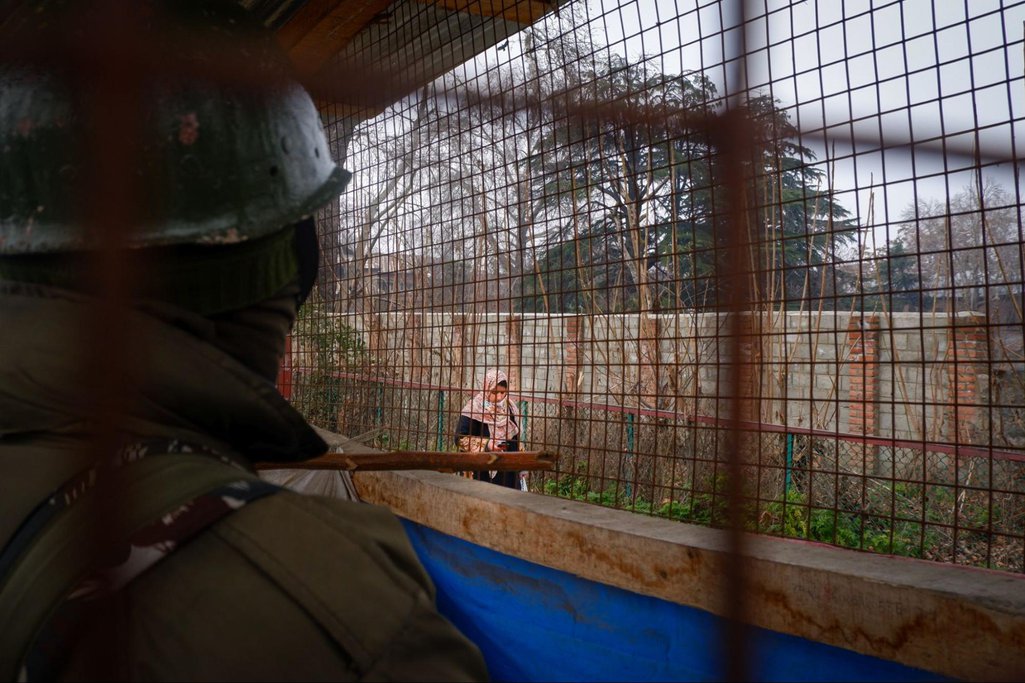 A member of the Indian paramilitary in a bunker beside the Jhelum River in Srinagar