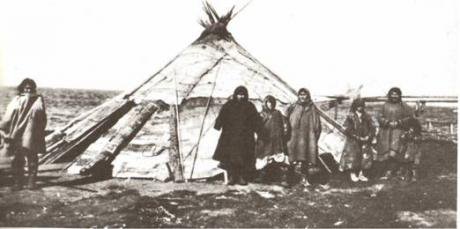 Black and white photo of a Khanty family in front of a &#39;chum&#39; [traditional nomadic dwelling] in the early 20th century
