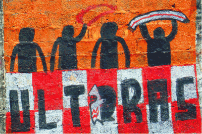 Silhouette figures over a red and white checked area with 'Ultras' written on it.