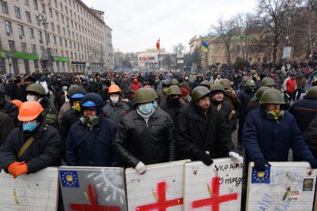 Formidable Looking Euromaidan activists with shields, hardhats and face coverings.