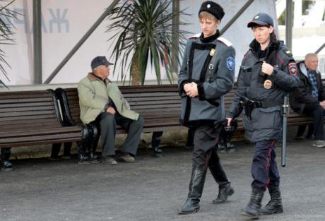 A Cossack and police officer patrol the streets of Sochi during the 2014 Winter Olympics. (c) RIA Novosti/Maksim Bogodvid