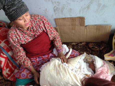 Woman with baby wrapped in blankets