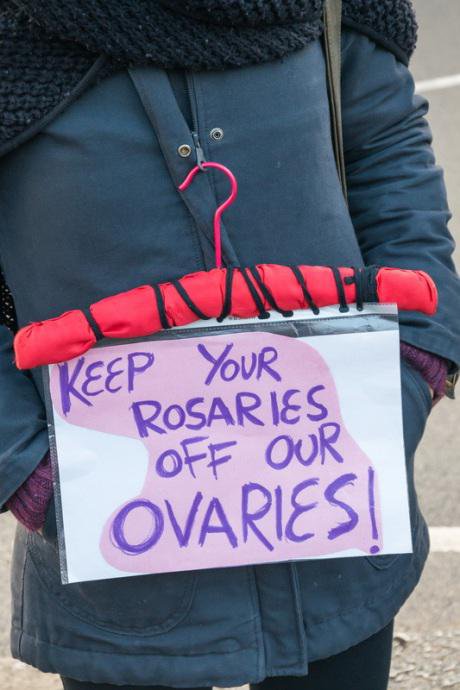 Hanger with message &#39;Keep your Rosaries off our Ovaries!&#39; at &#39;My Belly is Mine&#39; protest at Spanish embassy, London