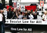 Demonstrators hold 'One law for all' banner