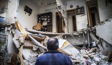 A civilian looks at a destroyed home in Aleppo, Syria. Andoni Lubaki/AP/Press Association Images. All rights reserved. 