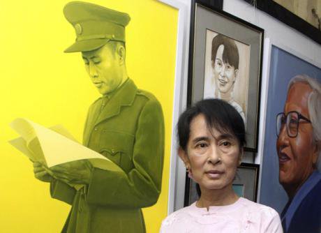 Aung San Suu Kyi poses by a painting of her father, Gen. Aung San. (Khin Maung Win AP/PA)