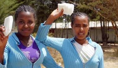 Students holding sanitary pads.