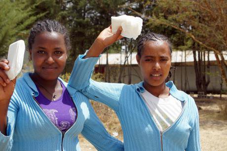 Students holding sanitary pads.