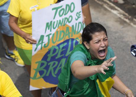 A demonstrator shouts slogans during a protest in Brazil in March. Credit: Silvia Izquierdo/AP/