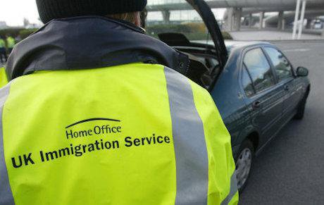 A UK Immigration officer checks cars crossing over from France. Gareth Fuller / PA Wire/Press Association Images