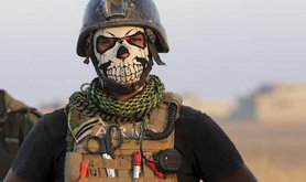 A member of Iraq's elite counterterrorism forces pauses as they advance towards the city of Mosul.