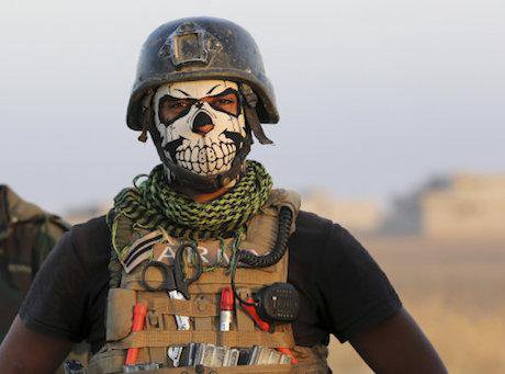A member of Iraq's elite counterterrorism forces pauses as they advance towards the city of Mosul.