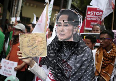 A woman wears a mask of Aung San Suu Kyi during a rally in Jakarta against the persecution of Rohingya. (Dita Alangkara; AP/PA)