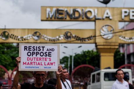 Protesters call for an to end martial law in Mindanao.