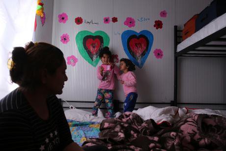 A refugee woman and her daughters at a refugee camp north of Athens.