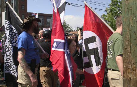 Demonstrators carry confederate and Nazi flags during the Unite the Right rally in Charlottesville, Virginia, August 2017.