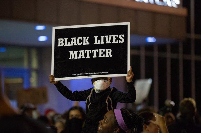 Protester holds up a Black Lives Matter sign at a protest in St Louis in September 2017