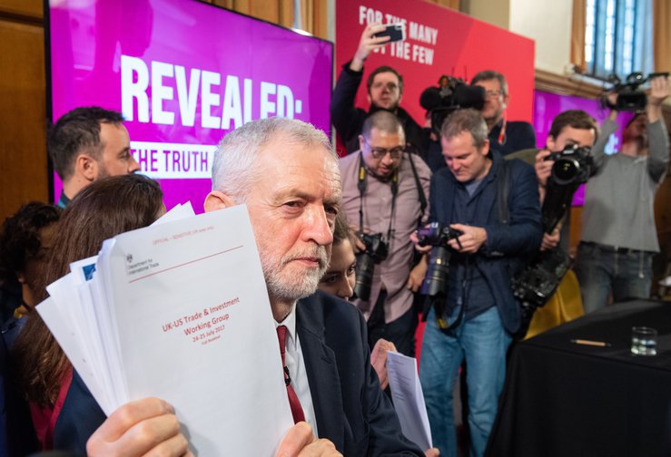Jeremy Corbyn holds an unredacted copy of a readout of the US/UK working group talks on a trade deal.
