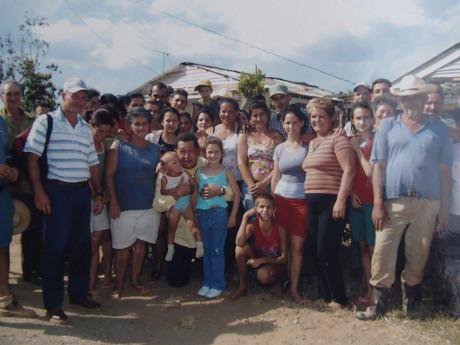 Hugo Chavez surrounded in a tight group by people of San Andres following a hurricane 
