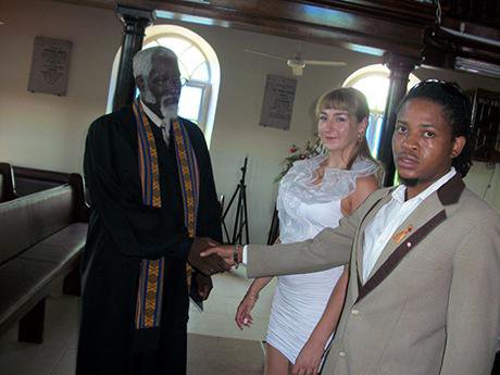 Man and woman in church with priest 