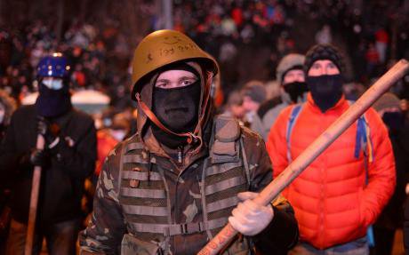 Militant protester on the Maidan with armour, a stick and helmet. 