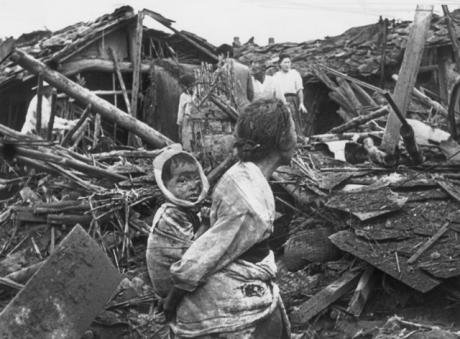 People surrounded by a devastated city.