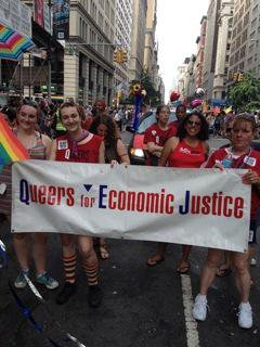 Group of people hold a &#39;Queers for Economic Justice&#39; banner