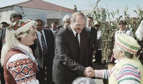 Belarusian President Alyaksandr Lukashenka meets with villagers in traditional clothing.