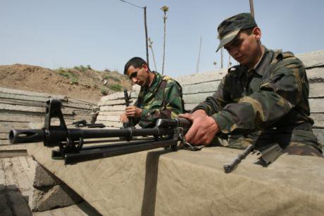 Nagorno-Karabakh troops clean their weapons in their trench on the &#39;line of contact&#39; 