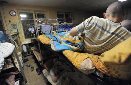 Addicts on tightly backed bunk beds in City Without Drugs dormatory