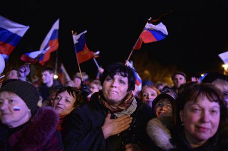 Crimeans with Russian flags celebrate the passing of their referendum calling for unification with Russia.