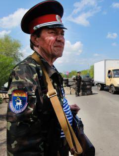 A Don Cossack guards a checkpoint near the entrance to Luhansk. 