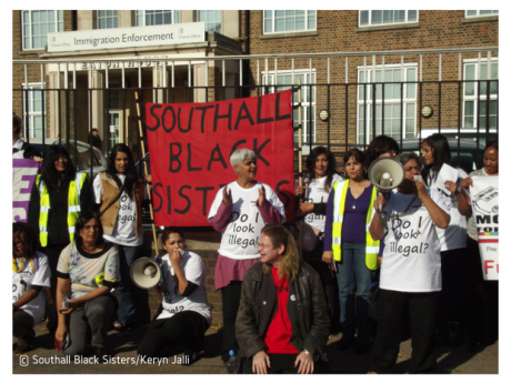 Women demonstrating with a Southall Black Sisters banner and megaphone