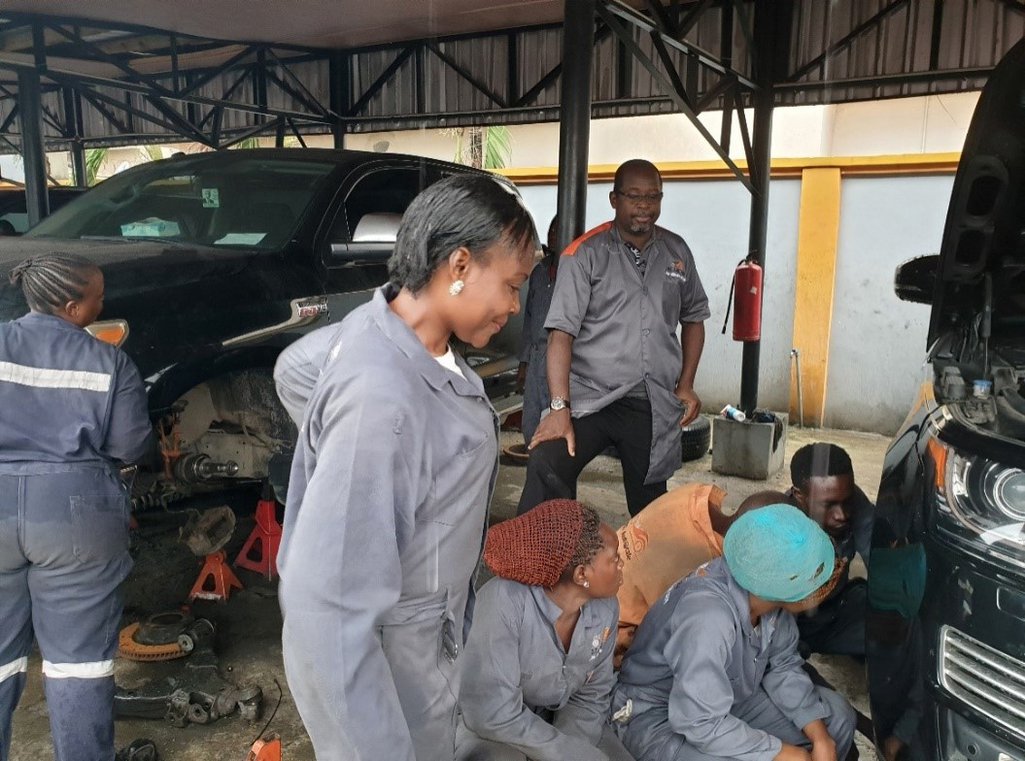 Several people working on a car